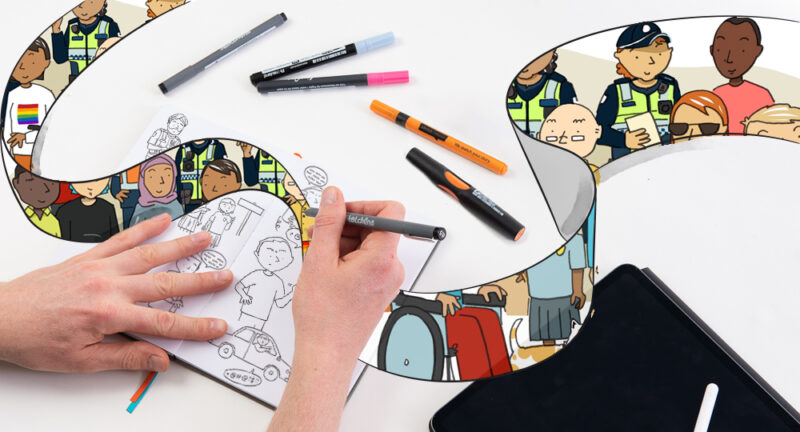Hand drawing comics in a sketchbook on a white table scattered with colored markers.