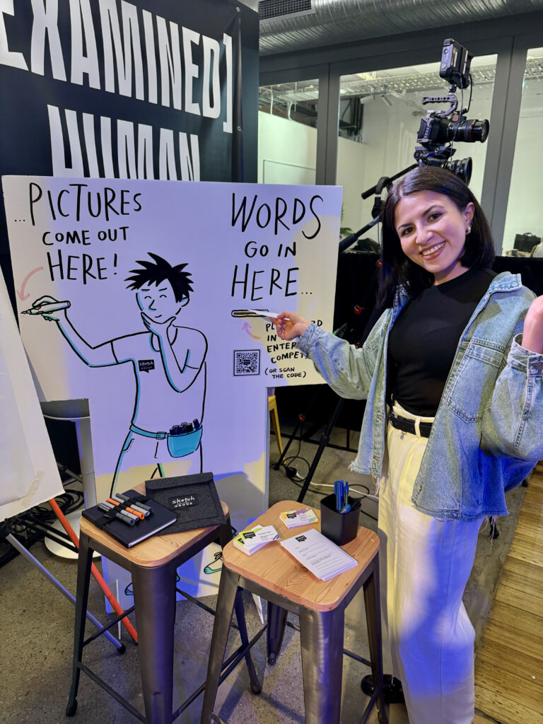 Attendee holding a prompt card, ready to participate in IdeaSketch™